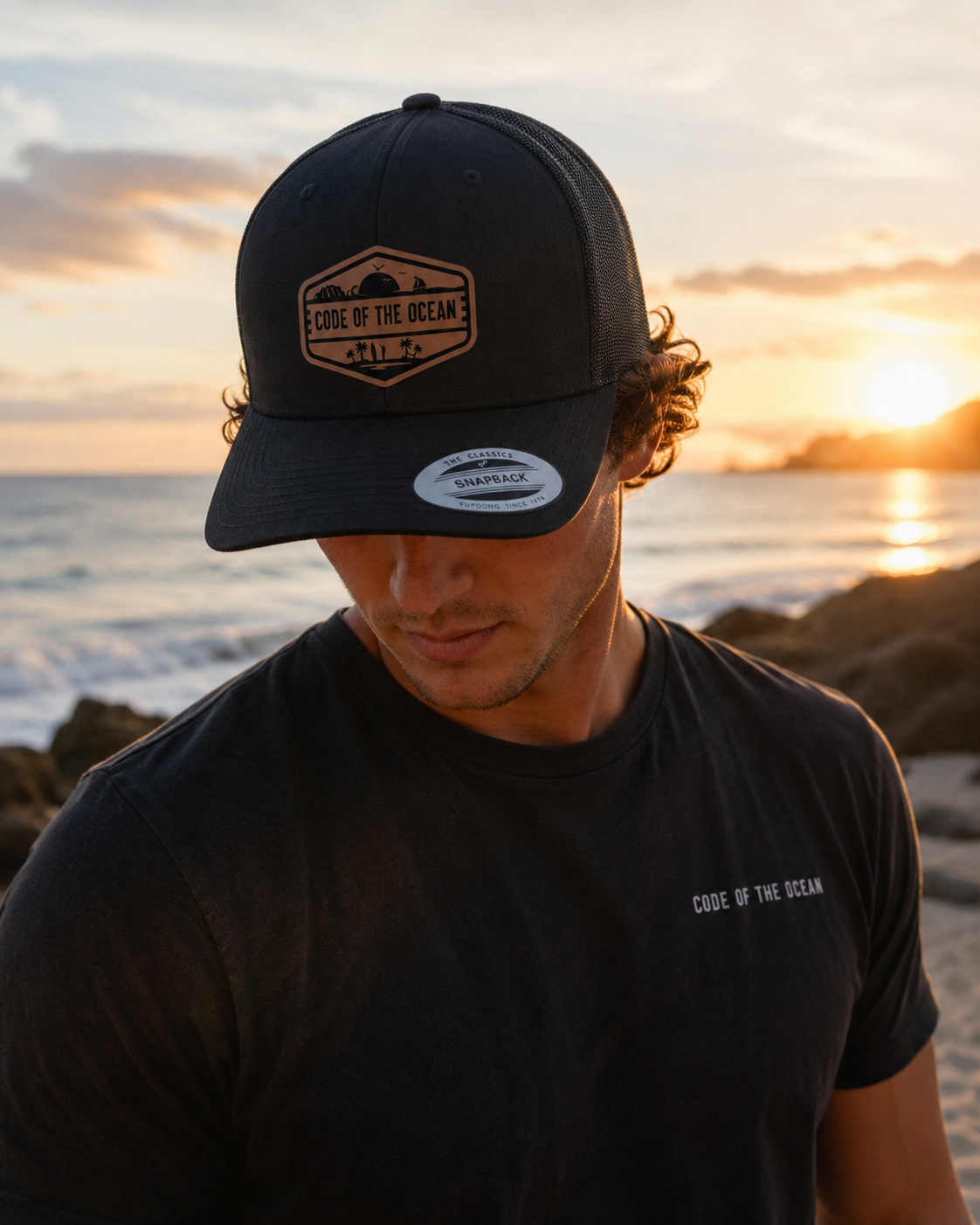 Trucker hat in black with Code of the Ocean leather patch